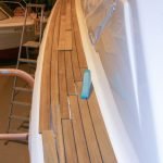 Auf den Seiten der Chris Craft MX 25 Motoryacht wird beim Refit ein neues Teakstabdeck verlegt in der Werfthalle der Bootswerft Baumgart in Dortmund