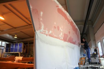Schleifarbeiten am Rumpf einer Comfortina 38 in der Werfthalle der Bootswerft Baumgart in Dortmund